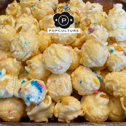 Popcorn with colorful sprinkles in a wooden bowl, featuring the Popculture logo.