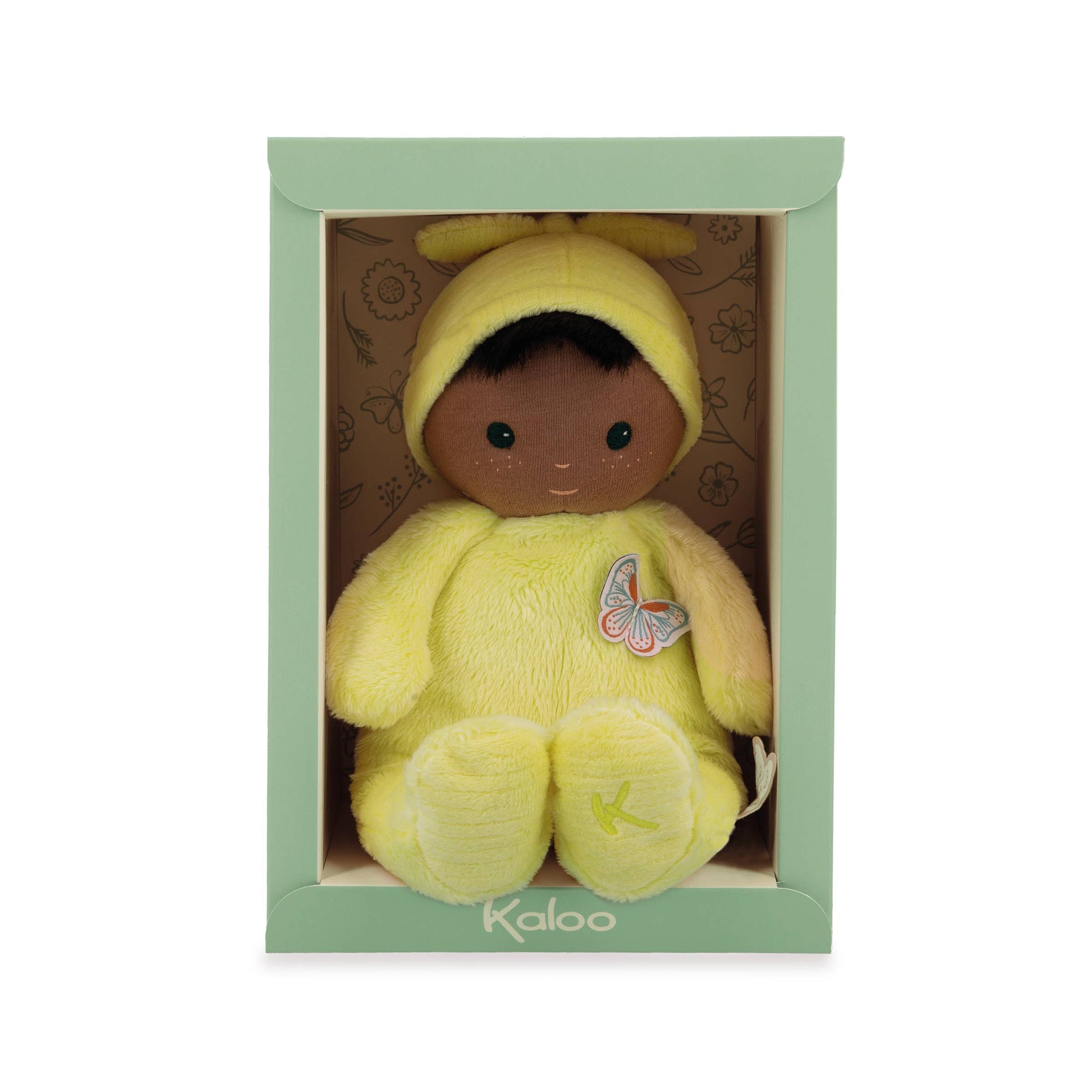 Yellow plush toy with a butterfly patch in a green box, brand 'Kaloo' visible