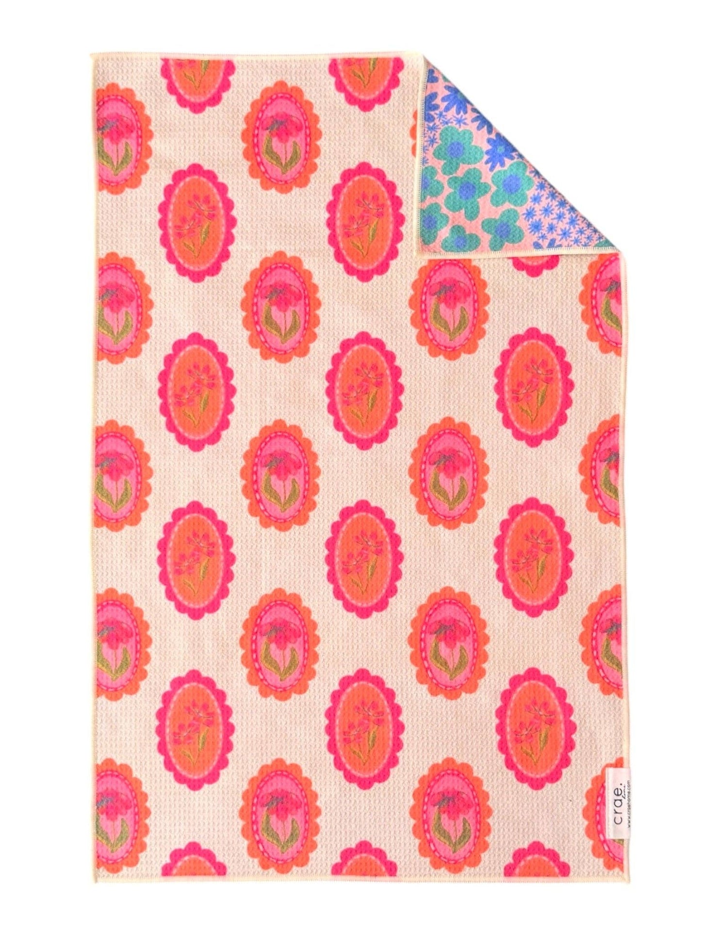 Colorful patterned towel with pink floral design on a white background