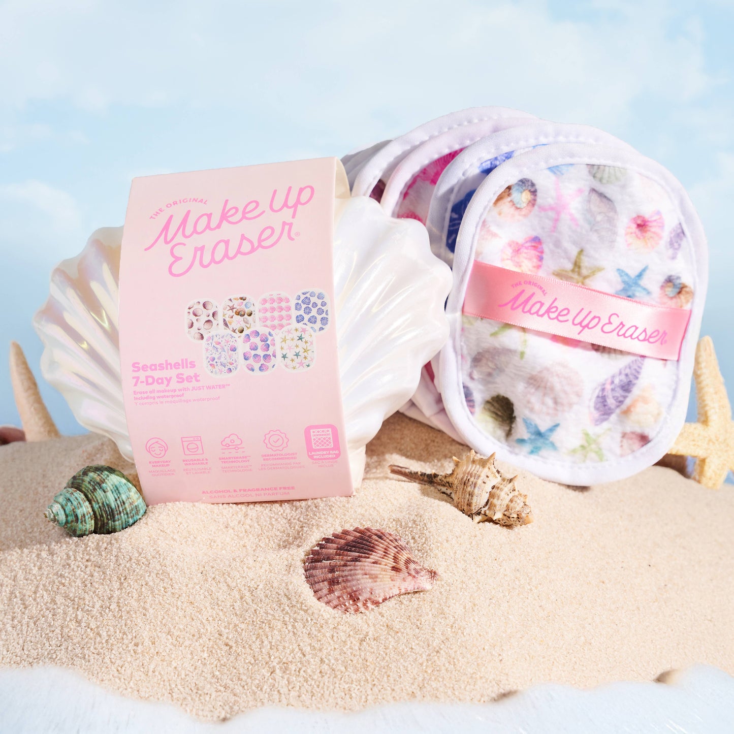 Make-up eraser set with packaging on a sandy background with shells