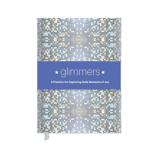 Notebook with glittery cover and blue banner displaying 'glimmers' on a white background