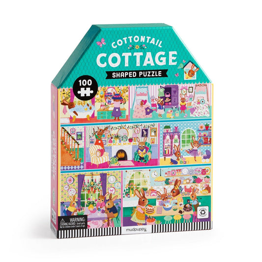 Cottontail Cottage shaped puzzle packaging with colorful illustrations on a white background