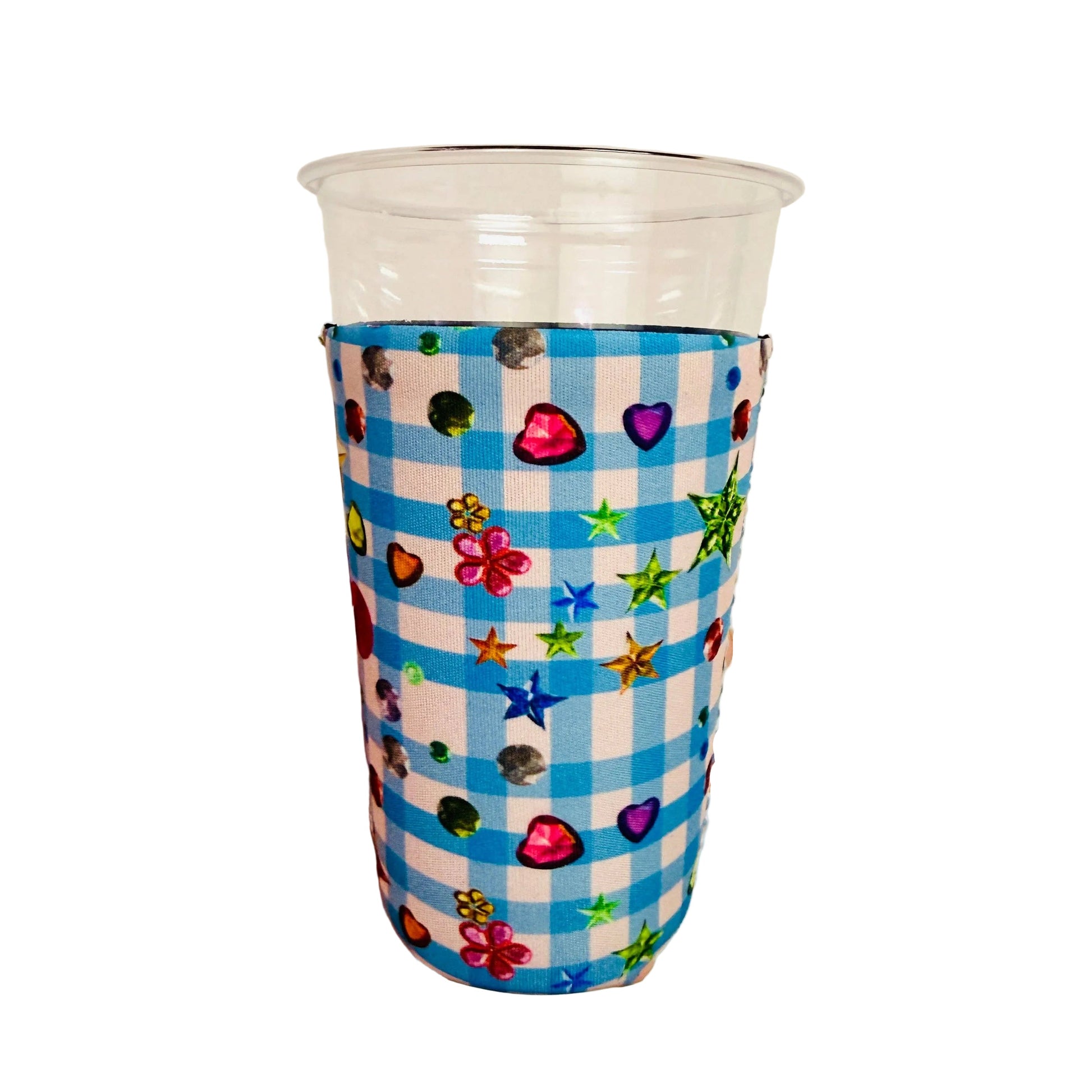 Clear plastic cup with a colorful patterned sleeve with photorealistic gemstones shaped like hearts,stars,flowers and more against a plain background 