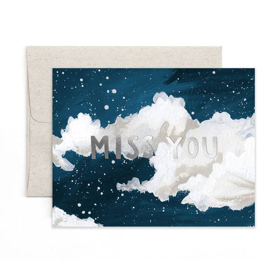 Greeting card with 'Miss You' text on a cloud design, accompanied by an envelope.