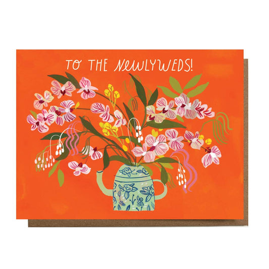 Greeting card with floral design and 'To the Newlyweds!' text on an orange background