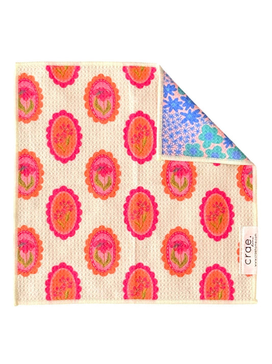 Floral patterned cloth with a brand label on a white background