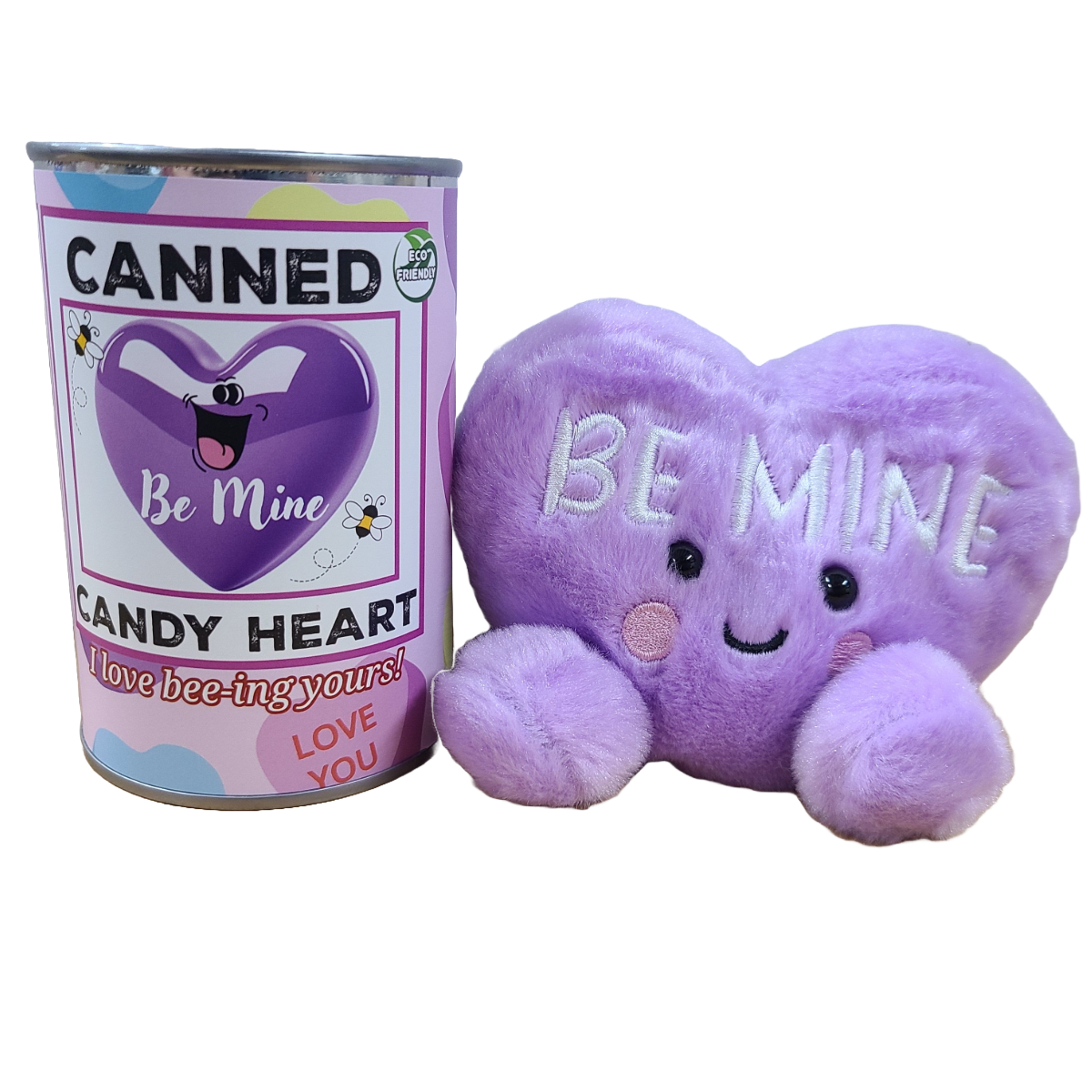Purple plush heart with 'Be Mine' text next to a can labeled 'Canned Candy Heart'.