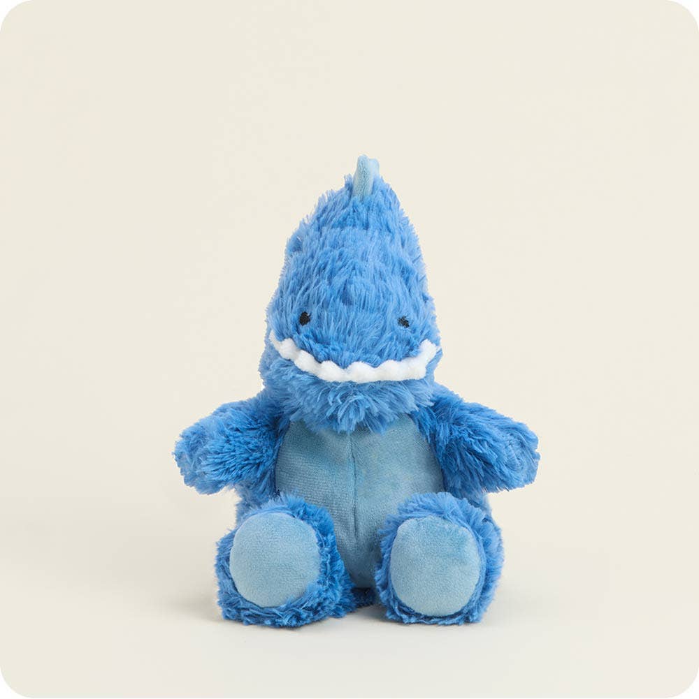 Blue plush toy with a smiling face on a light beige background