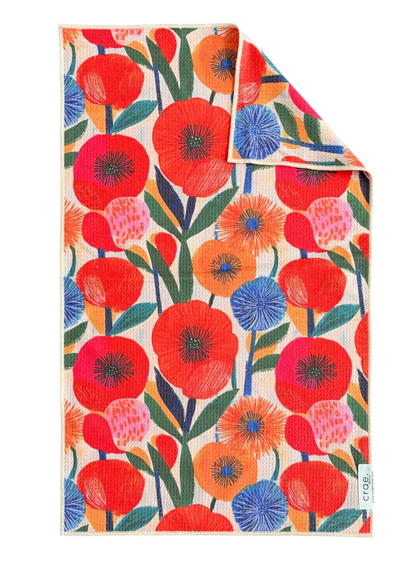 Colorful floral patterned towel with red, orange, and blue flowers on a white background