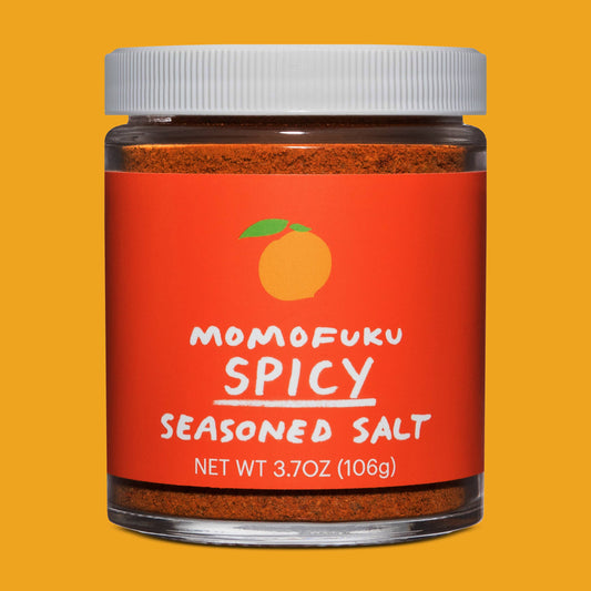 Jar of Momofuku Spicy Seasoned Salt on a yellow background