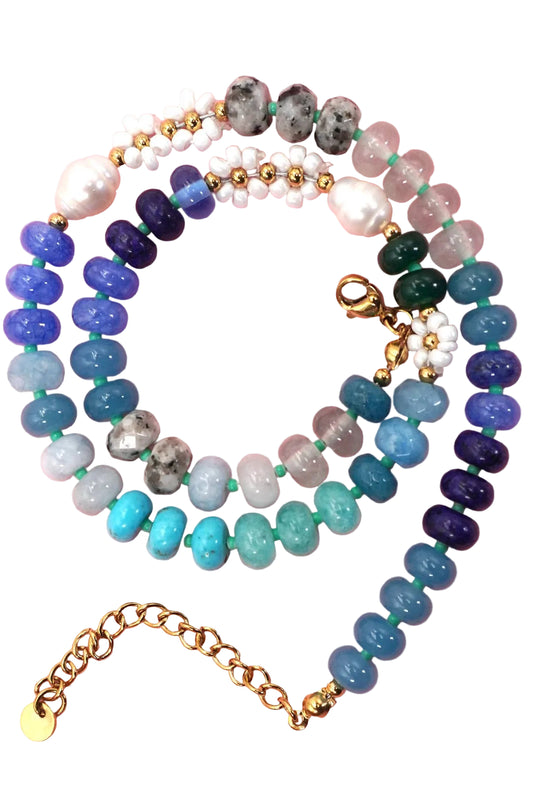 Stack of colorful beaded bracelets on a pink background