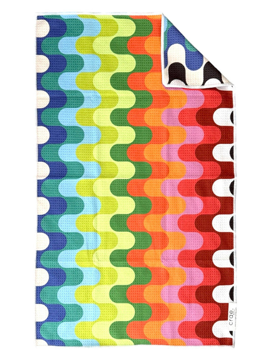 Colorful patterned blanket with wavy design on a white background