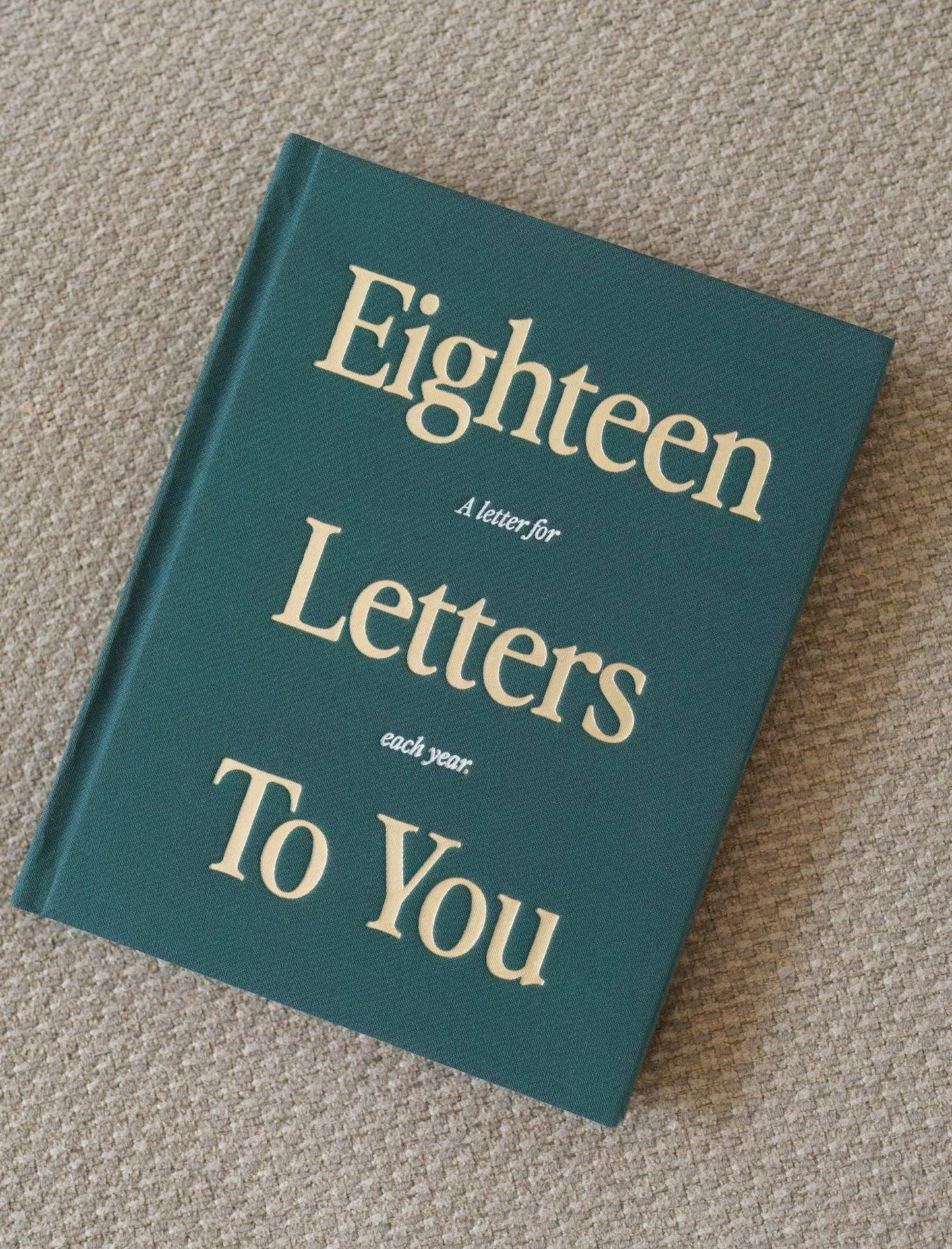 Book titled 'Eighteen Letters To You' on a textured surface