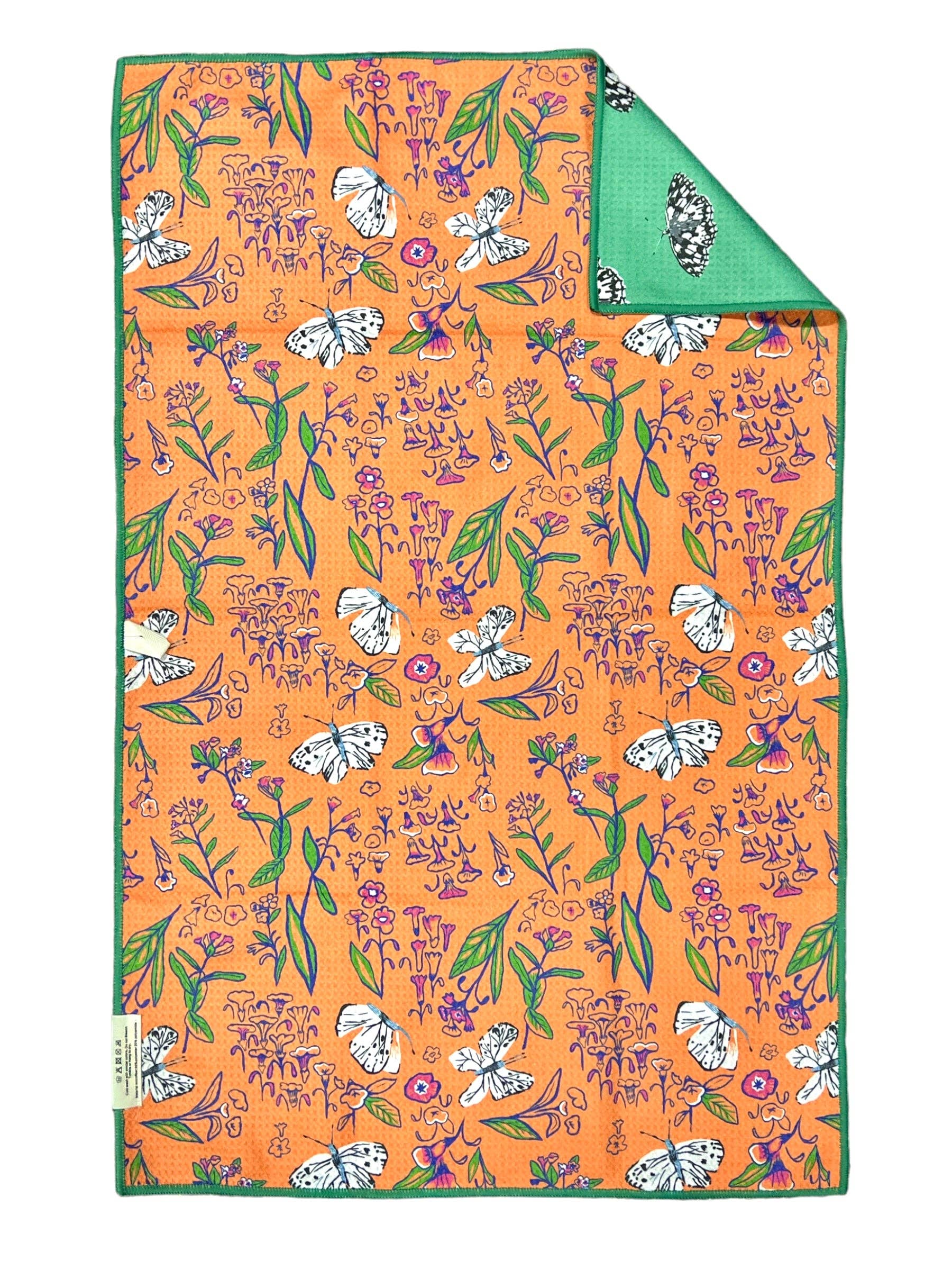 Floral patterned fabric with a green border on an orange background