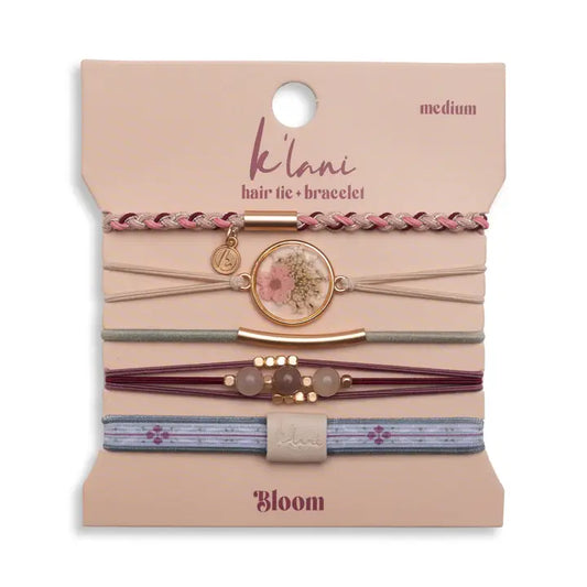 Set of hair ties and bracelets on a 'ke'lani' branded card with 'Bloom' design.
