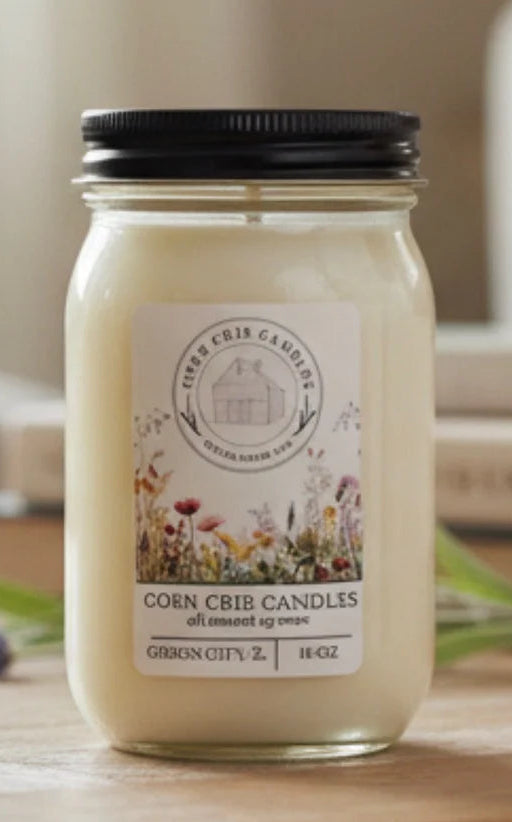 Jar candle with a  floral label on a wooden surface, blurred background