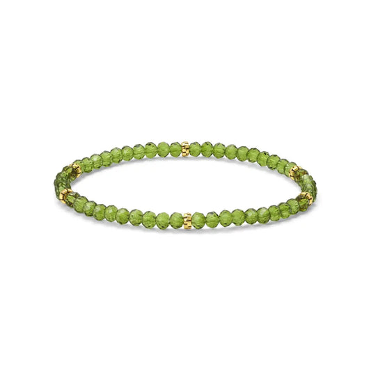 Peridot green beaded bracelet with gold accents on a white background