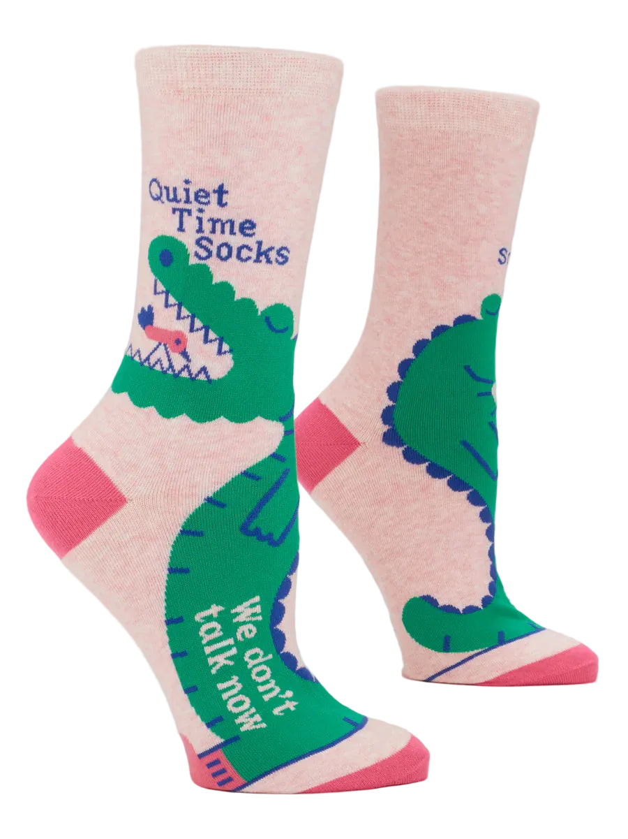 Pink socks with green alligator design and text on a white background