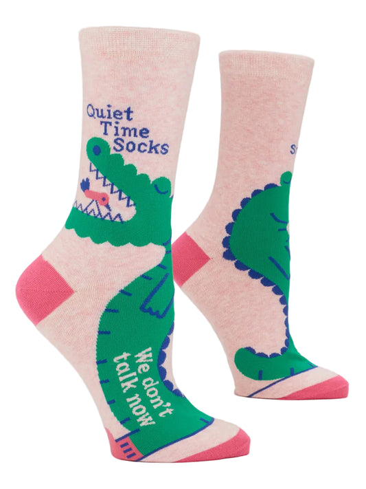 Pink socks with green alligator design and text on a white background