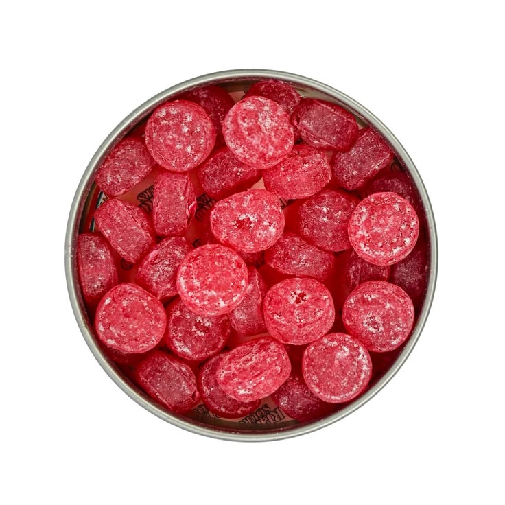 Top-down view of round, translucent pink-red candies coated in sugar, filling a round metal tin against a white background.