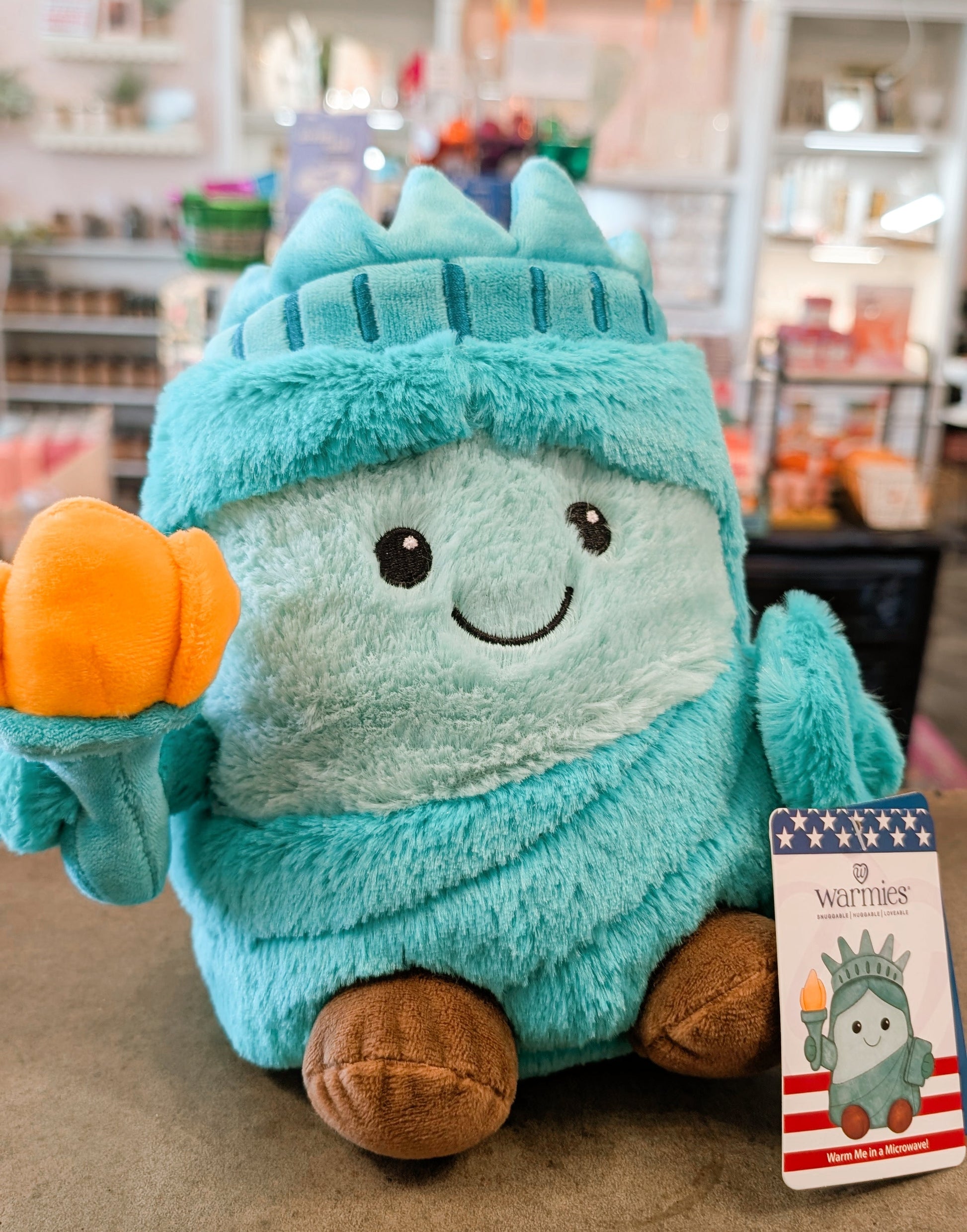 Toy resembling the Statue of Liberty with a pumpkin, in a store setting