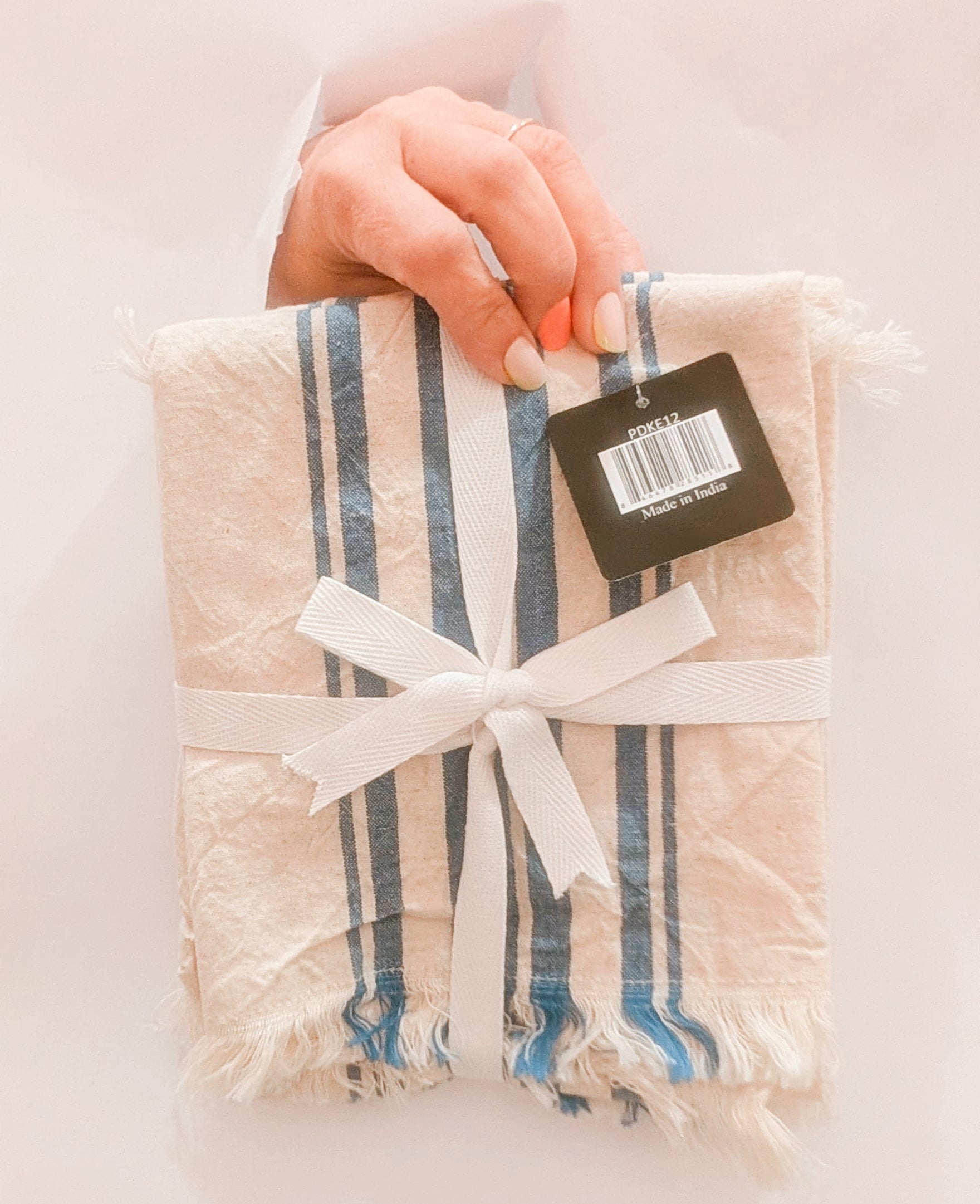 Packaged product with a ribbon and tag on a light background
