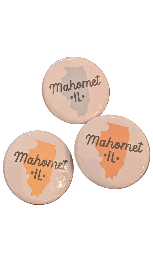 Three round pins with 'Mahomet, IL' text and map outline.