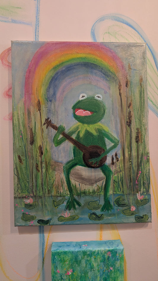 kermit the frog sitting by a pond holding a banjo with a rainbow and vibrant background