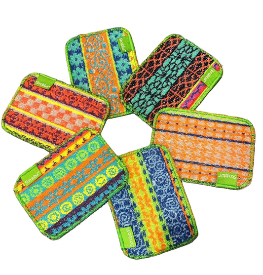 Colorful patterned washcloths arranged in a star shape on a white background