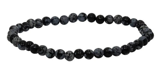 A beaded stretch bracelet made of dark, round snowflake obsidian beads, displayed on a clean white background 