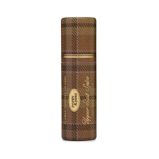 Brown plaid lip balm with gold accents on a white background